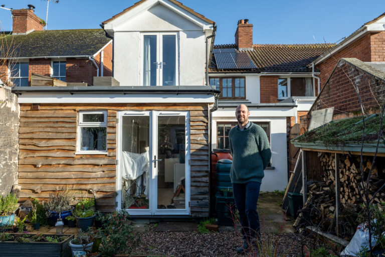 Alastair stood outside his house that has had a number a retrofit upgrades