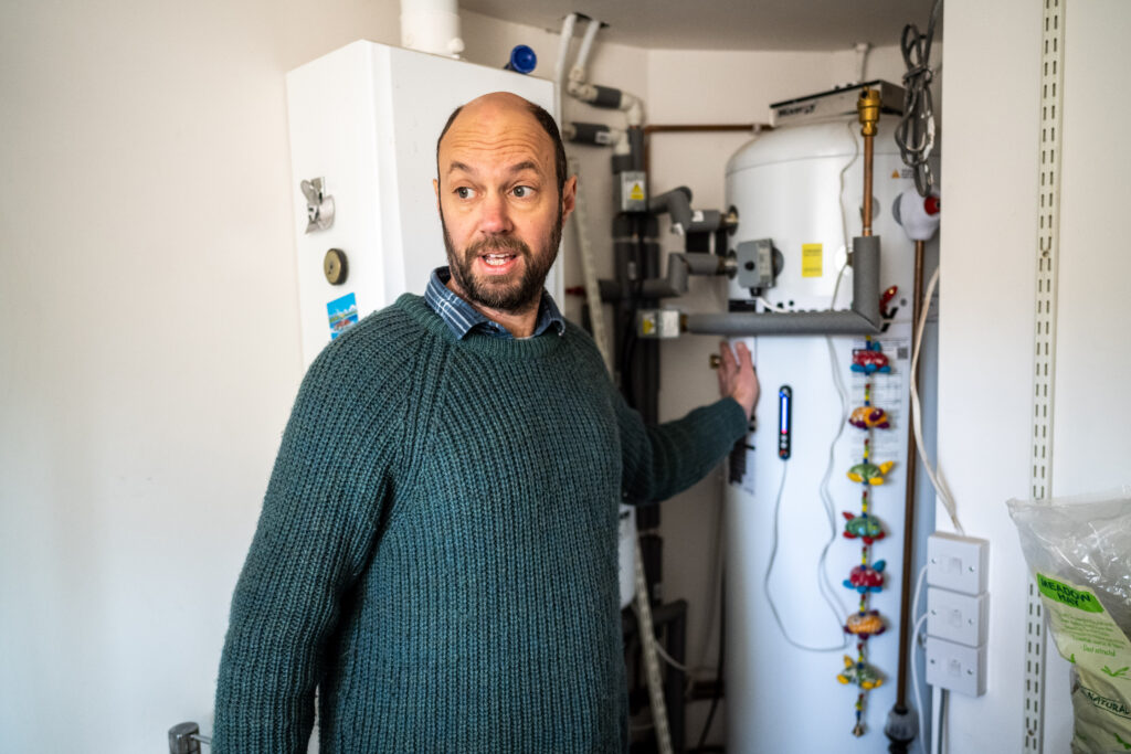 Alastair in front of energy efficient boiler