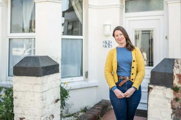 Nicky standing outside her home in Plymouth